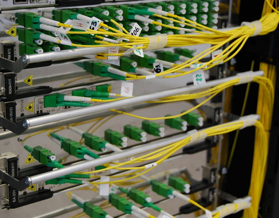 A rack of green and yellow wires in the middle of a room.