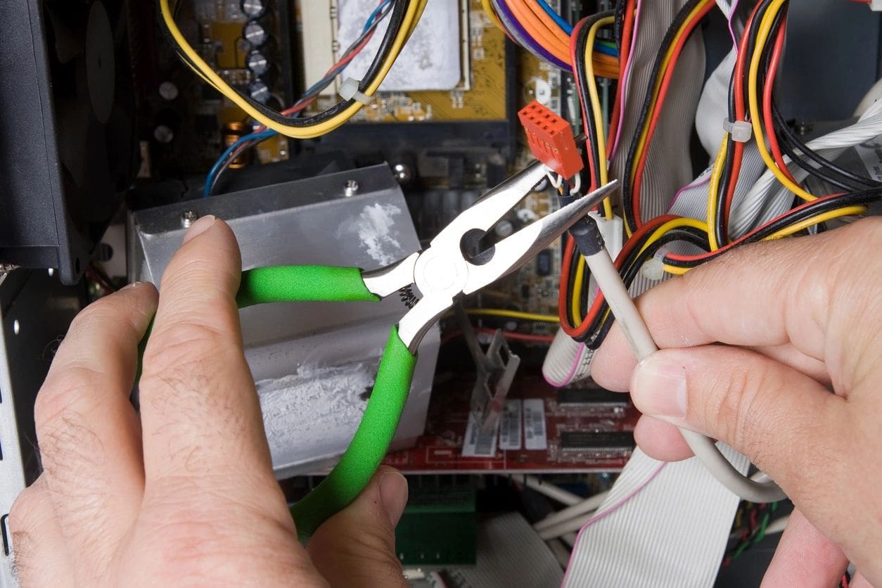 A person holding some green pliers in their hand