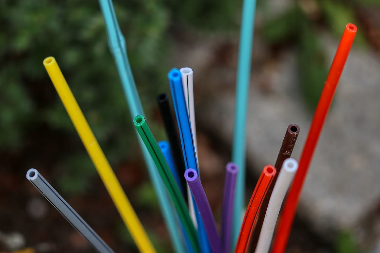 A close up of many different colored straws